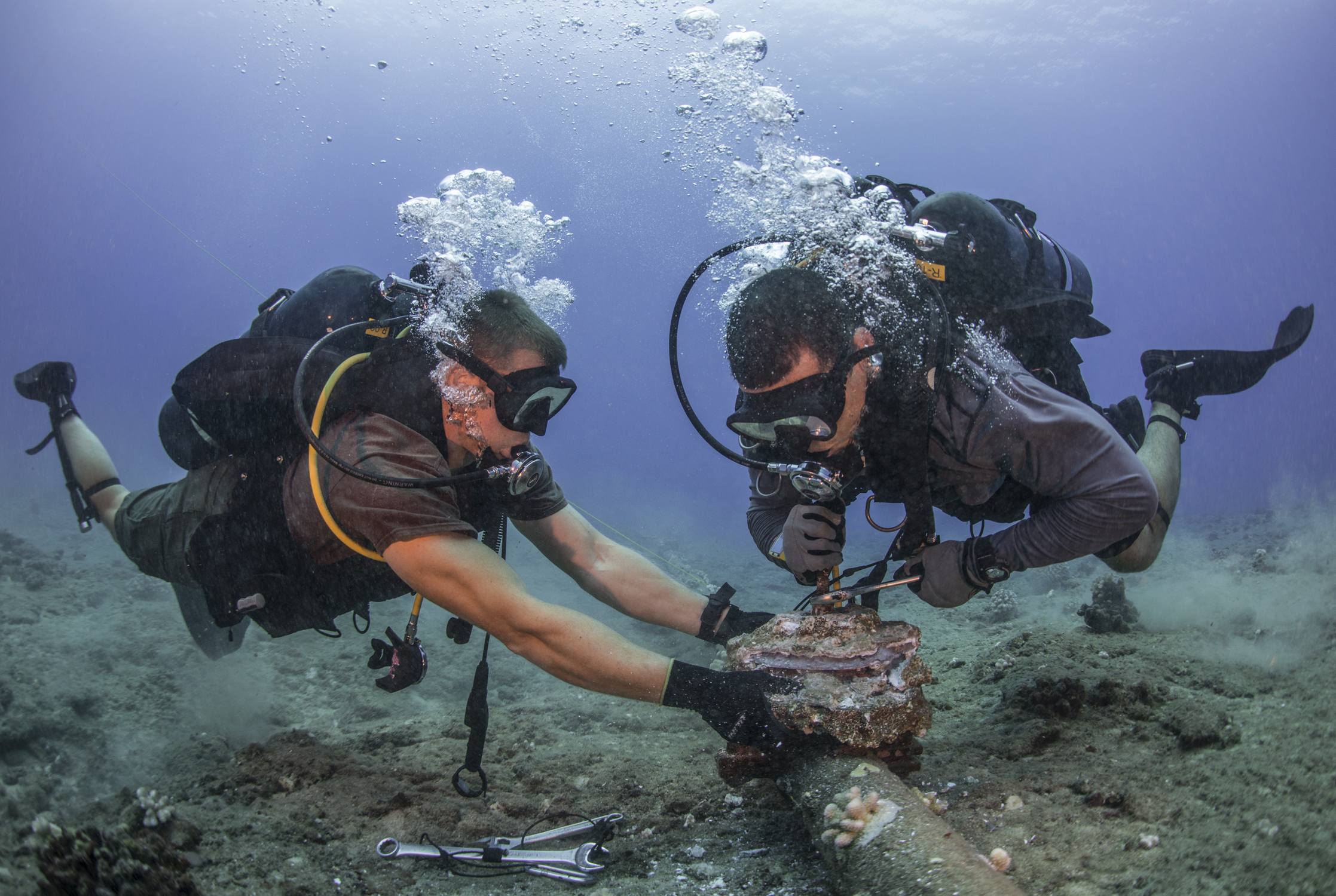 This is an image of Sailors performing undersea cable maintenance at the Pacific Missile Range Facility Barking Sands, Hawaii.